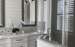 A picture of a beautiful luxury bathroom with cabinet and mirror installation on it